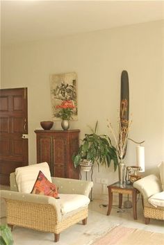 a living room filled with furniture and plants