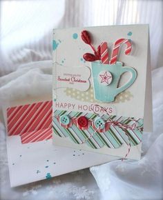 two christmas cards with candy canes in a cup on the front and one has a red ribbon