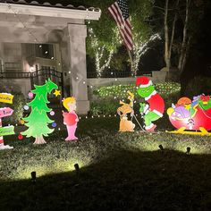 christmas lights in the shape of cartoon characters are on display at a home's front yard