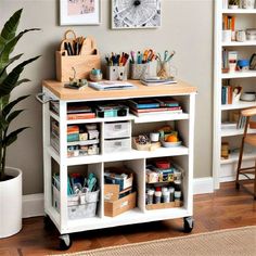 a white shelf with lots of craft supplies on top of it next to a potted plant