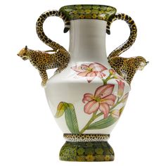 a white vase with leopards and flowers painted on it