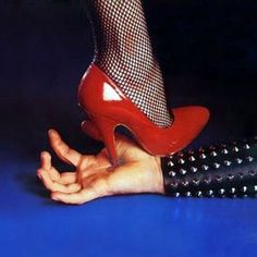 a woman's legs with fishnet stockings and high heels on top of her leg