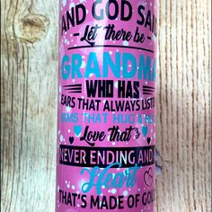 a pink and blue water bottle sitting on top of a wooden table