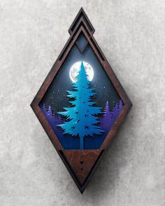 a wooden wall hanging with a tree and moon in the night sky on it's side