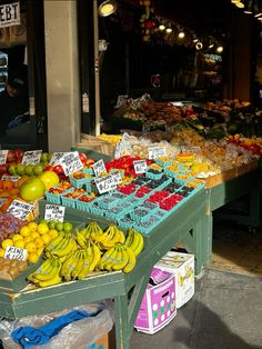 an outdoor market with fruits and vegetables on display