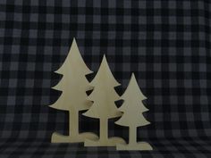 three wooden trees on a black and white checkered background