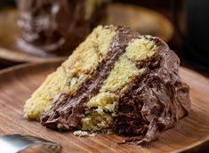 a piece of chocolate cake on a wooden plate