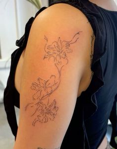 a woman with a flower tattoo on her arm