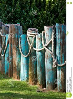 old wooden posts with ropes attached to them