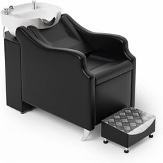 a black chair with a white sink and footstool on it's side