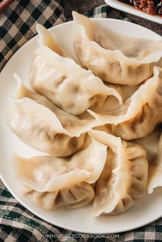 some dumplings are on a white plate