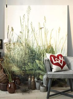 a living room filled with lots of furniture next to a painting on the wall and floor