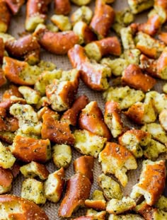 closeup of cooked sausages on a baking sheet with seasoning sprinkled