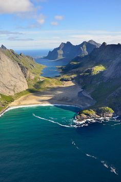 an aerial view of the ocean and mountains