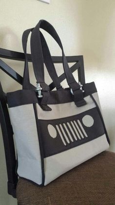 a white and black bag sitting on top of a chair