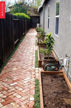 a brick path leading to a house with potted plants in the front and side