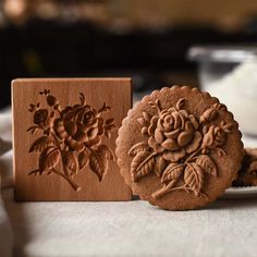 there are two cookies on the table next to each other and one is decorated with flowers