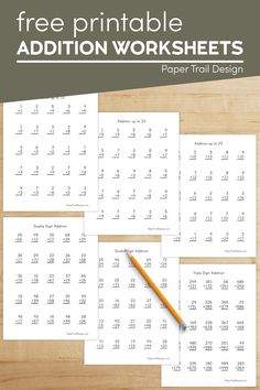 the printable addition worksheets are on top of a wooden table