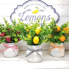 three mason jars filled with lemons and oranges