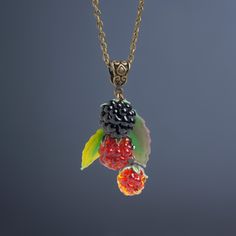 This Blackberry lampwork necklace is so fresh and natural that it seems real! If you like Nature, berries and originality, this berry pendant is for you! Set Matching pendant: https://www.etsy.com/listing/550609985 Matching earrings: https://www.etsy.com/listing/252353682 Matching earrings: https://www.etsy.com/listing/161749334 Dimensions: pendant 6.5cm, brass colored metal chain 44-49 cm. Materials: artist lampwork beads, metal fittings. Colors used: dark red, red, black, green. Please, note, Berry Colored Fruit Design Jewelry Gift, Berry Jewelry, Berry Necklace, Lampwork Pendant, Lampwork Necklace, Fruit Necklace, Nature Necklace, Food Jewelry, Necklace Red