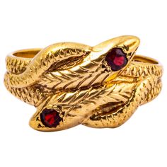 This stunning ring featured two snakes that are wrapped around each other to create this ring. The serpents have a round cut garnets on top of each of their heads. Modelled in 9ct gold and made in Birmingham, England. Ring Size: Y or 10 Width At Widest Part: 9mm Weight: 5.6g Antique Snake Ring As Gift, Antique Hallmarked Snake Ring, Anniversary Gemstone Snake Ring, Anniversary Snake Ring With Gemstone, Two Snakes, Serpent Snake, Serpent Ring, Gold Teeth, Garnet And Gold