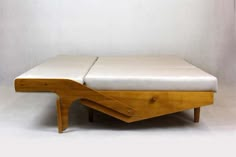 a bed that is sitting on top of a wooden frame