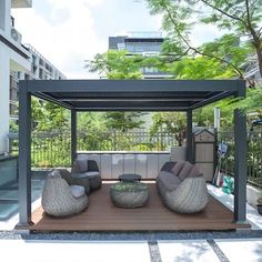 an outdoor living area with couches and tables