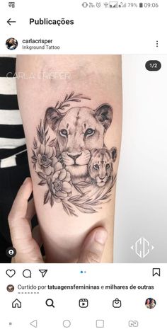 a lion and cub tattoo on the arm