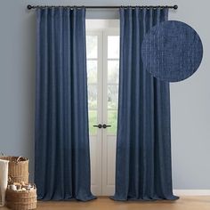 a blue curtain hanging on the side of a door next to a basket and wicker basket