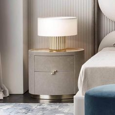 a bedroom with a bed, nightstand and lamp on the side table in front of it