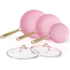 the pink pans are next to each other with gold handles and glass lids on them