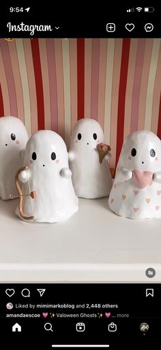 five little white ghost figurines sitting on top of a table