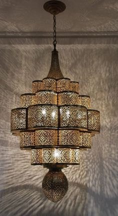 Fabulous finely handcrafted and hand chased Moroccan Moorish brass Alhambra hanging chandelier.This Alhambra Moroccan chandelier is made of brass and delicately handcrafted, hand-chase, hand-hammered and chiseled, the brass become a Fine art like a piece of jewelry.Size: Brass body: 31 inches diameter x 53" height.Without the chains: total height 53"H.Rewired in the US . Ready to use.Additional chains length could be added to your needs.The chandelier is light it weight approximately 16 lbs.Very delicate brass metal artwork in Islamic Moorish Andalusian filigree.Handcrafted in Marrakech Morocco by skilled artisans.Circa 1980s. Morocco Restaurant, Moroccan Accessories, Moroccan Light Fixture, Brass Tray Table, Moroccan Tent, Moroccan Chandelier, Moroccan Wedding Blanket, Islamic Style, Moroccan Home Decor