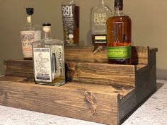 several bottles of alcohol sit on top of a wooden box