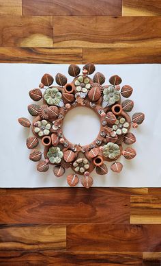 an arrangement of clay flowers arranged in a circle