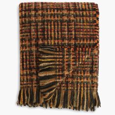 an orange and brown plaid blanket with fringes