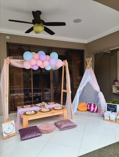 an outdoor party setup with balloons and decorations