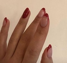 a woman's hand with red nail polish on it and an oval shaped manicure