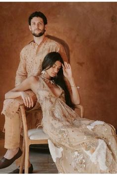 a man sitting next to a woman on top of a chair