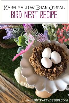 a bird nest with eggs in it on a white plate next to flowers and plants