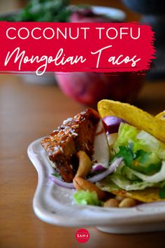 a close up of a plate of food on a table with the words coconut tofu mingblain tacos