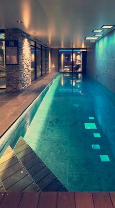 an indoor swimming pool with steps leading up to it