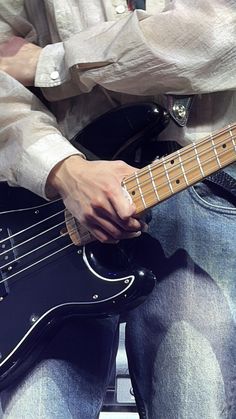 a man is playing an electric guitar