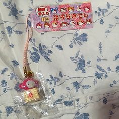 a hello kitty keychain is on the bed