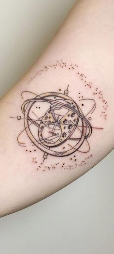 a tattoo on the arm of a woman with an image of saturn and its satellites