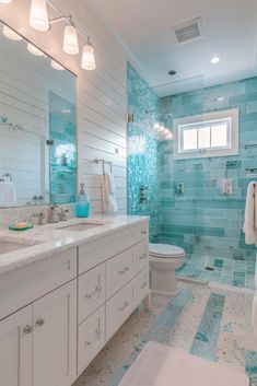 a bathroom with blue and white tiles on the walls, flooring and counter tops