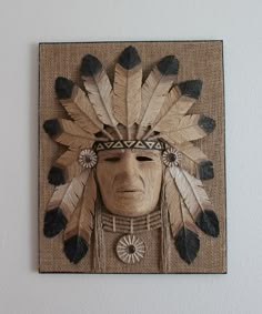 a native american headdress is mounted on the wall