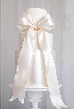 a white wedding cake with a large bow on top