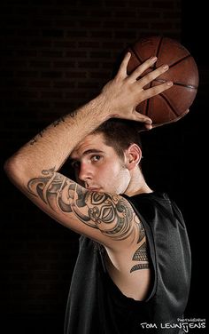 a man holding a basketball up to his face