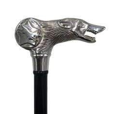 a metal head on top of a black pole with an animal's face in the middle